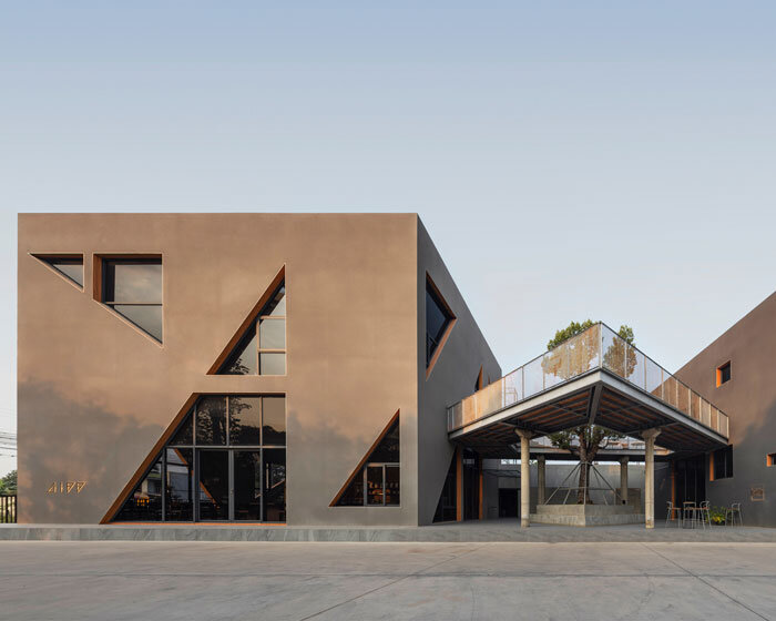 triangular skylights pierce café's concrete volumes by ASWA in thailand