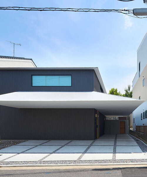 floating white eave slices through black volume of wooden residence by airhouse in japan