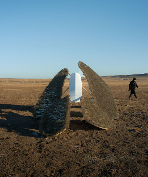 crafted with thatch and gauze, oas/s-nomad installation floats above mongolia's grassland