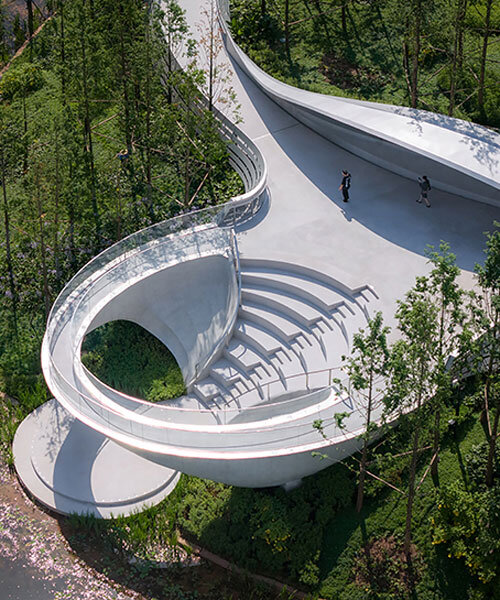 pedestrian bridge extends across luhu lake in chengdu forming an open-air ring pavilion